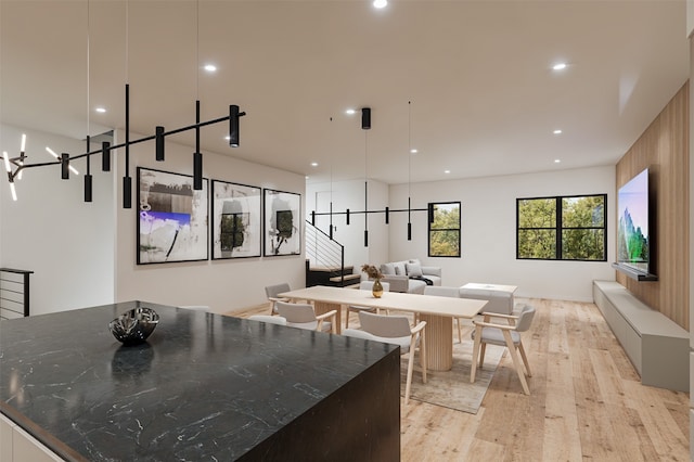 kitchen with a kitchen island, light hardwood / wood-style flooring, and decorative light fixtures