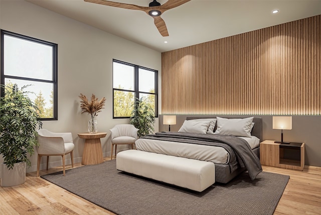 bedroom with light hardwood / wood-style flooring and ceiling fan