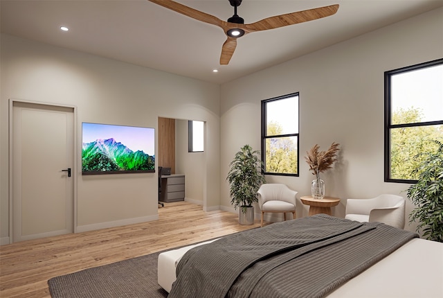 bedroom with light hardwood / wood-style floors and ceiling fan