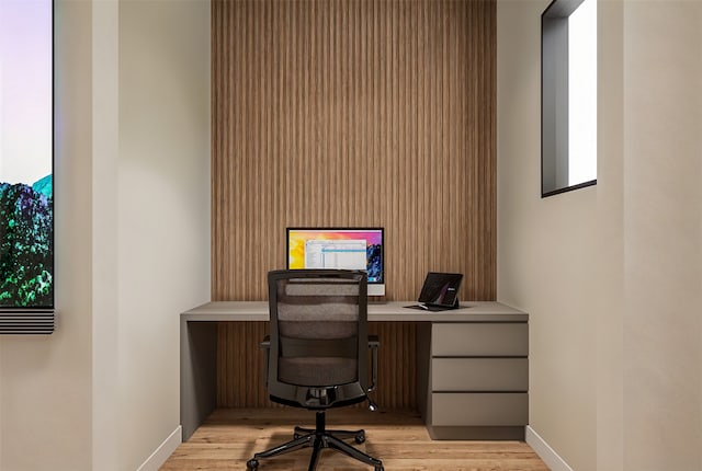 home office featuring built in desk and light hardwood / wood-style floors