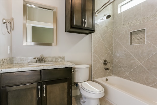 full bathroom featuring tiled shower / bath, toilet, and vanity