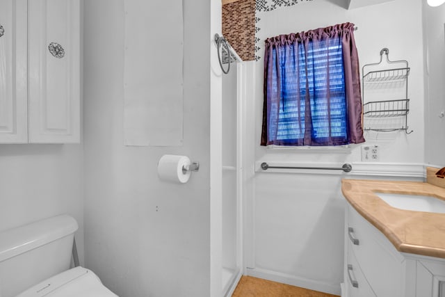 bathroom featuring toilet and vanity