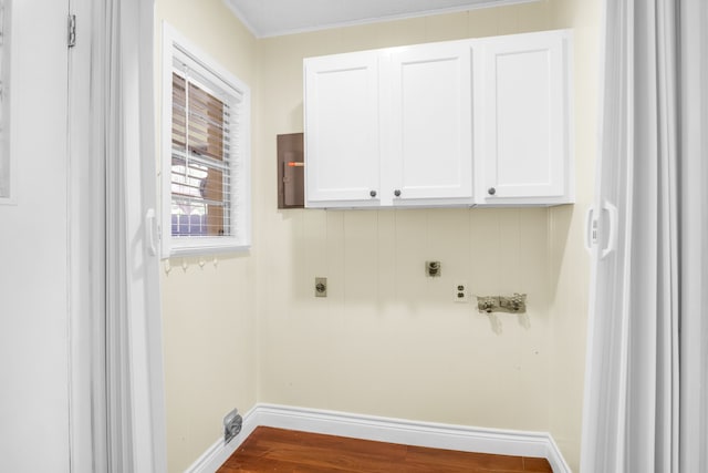 laundry area with crown molding, wood-type flooring, cabinets, and hookup for an electric dryer