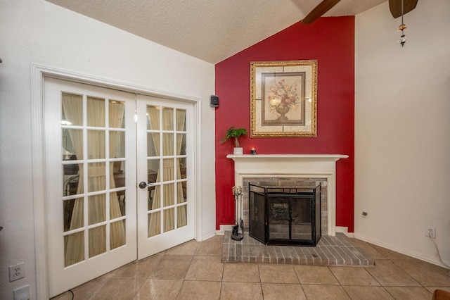 unfurnished living room with lofted ceiling, a brick fireplace, french doors, and a textured ceiling