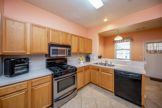 kitchen with a textured ceiling, light tile patterned floors, stainless steel appliances, sink, and kitchen peninsula