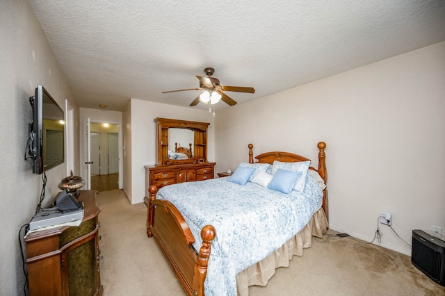 carpeted bedroom with a textured ceiling and ceiling fan