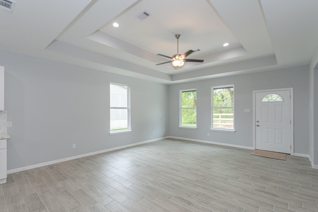 1022 Adams St, Cleveland, TX 77327 - unfurnished living room with a raised ceiling, a ceiling fan, light wood-style floors, and recessed lighting