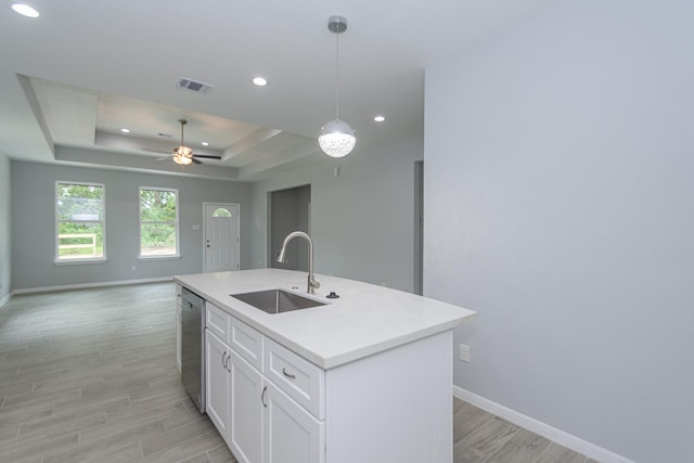 1022 Adams St, Cleveland, TX 77327 - kitchen featuring a sink, stainless steel dishwasher, baseboards, light wood-style flooring, and a raised ceiling