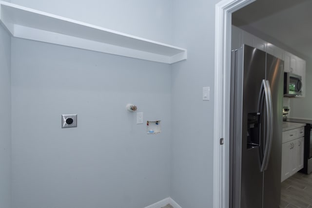 laundry room featuring hookup for a washing machine, hardwood / wood-style flooring, and electric dryer hookup