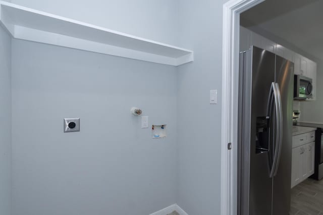 1022 Adams St, Cleveland, TX 77327 - laundry room featuring electric dryer hookup, hookup for a washing machine, and baseboards