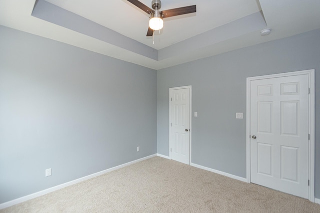 1022 Adams St, Cleveland, TX 77327 - carpeted empty room featuring a raised ceiling, a smoke detector, baseboards, and a ceiling fan