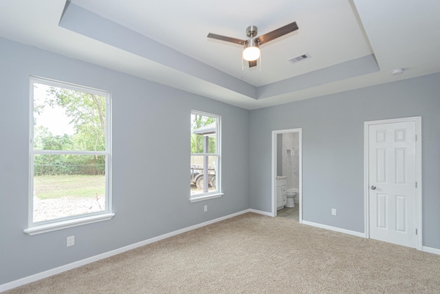 1022 Adams St, Cleveland, TX 77327 - unfurnished bedroom featuring a raised ceiling, light colored carpet, baseboards, and ensuite bathroom