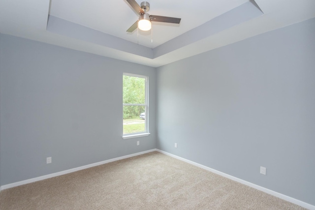 1022 Adams St, Cleveland, TX 77327 - carpeted empty room featuring a tray ceiling, baseboards, and ceiling fan