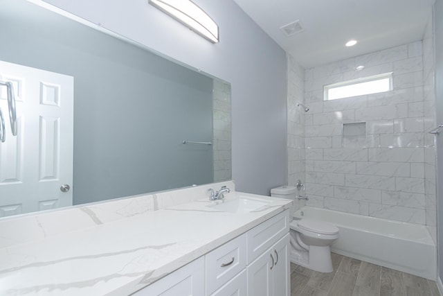 1022 Adams St, Cleveland, TX 77327 - bathroom with toilet, vanity,  shower combination, and wood finished floors