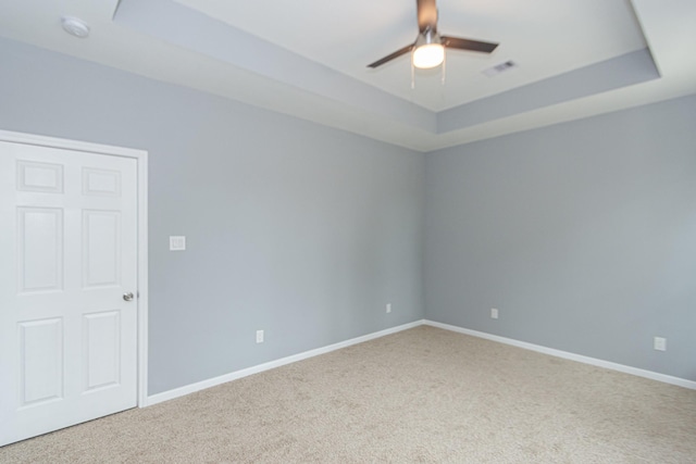 1022 Adams St, Cleveland, TX 77327 - carpeted spare room featuring a tray ceiling, a ceiling fan, baseboards, and a smoke detector