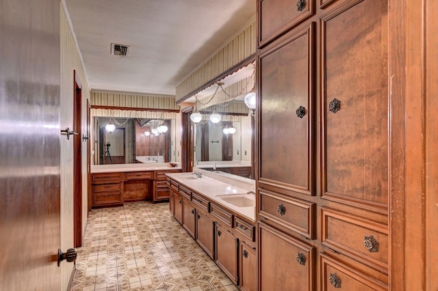 full bathroom featuring double vanity, a washtub, visible vents, and a sink