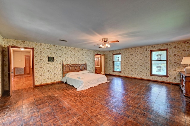 unfurnished bedroom with visible vents, wallpapered walls, baseboards, and a ceiling fan