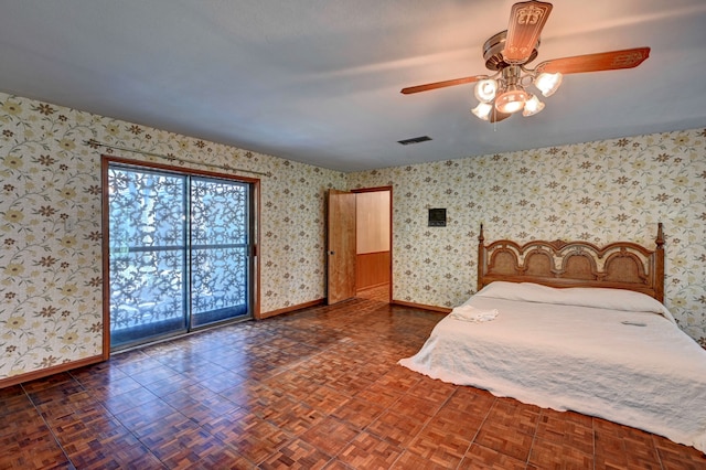 unfurnished bedroom with ceiling fan and dark parquet flooring