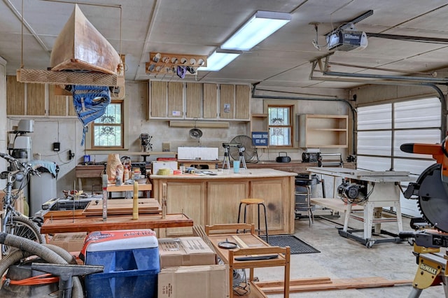 kitchen with concrete floors, light brown cabinets, and a healthy amount of sunlight