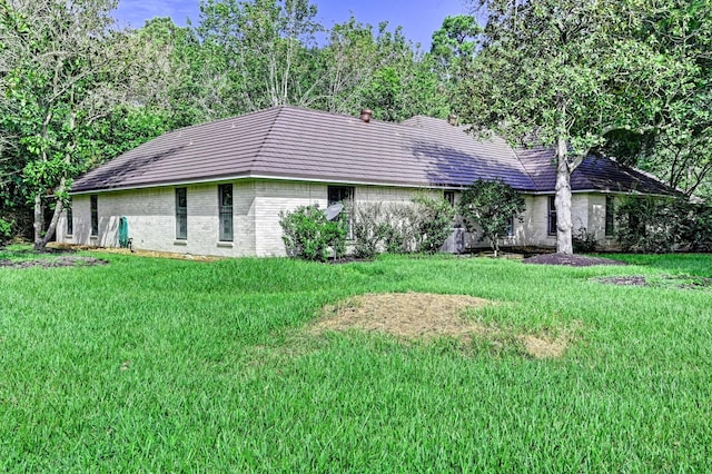 view of front of property with a front yard and brick siding