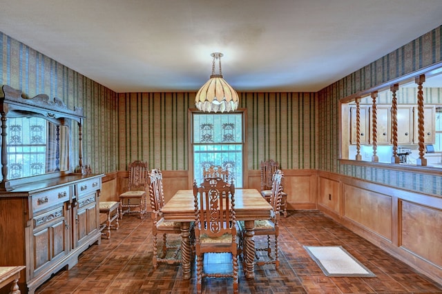 dining space featuring dark parquet floors