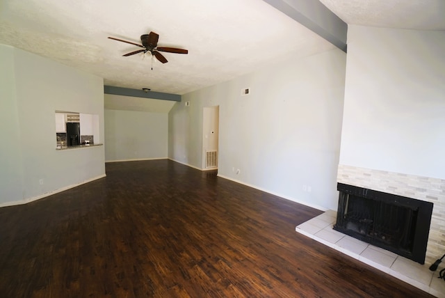 unfurnished living room featuring a textured ceiling, ceiling fan, a tile fireplace, and light hardwood / wood-style floors