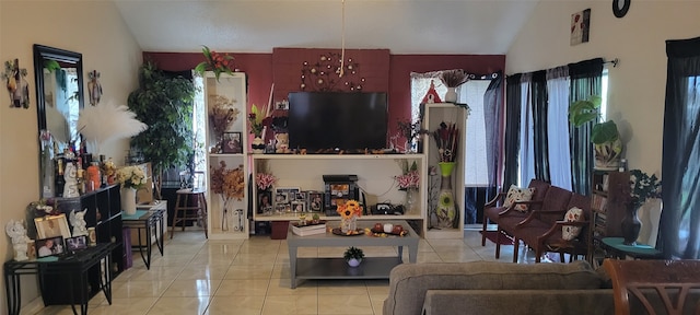 living room with vaulted ceiling, plenty of natural light, and light tile patterned floors