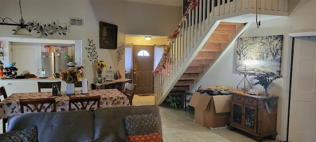 tiled dining room with a high ceiling