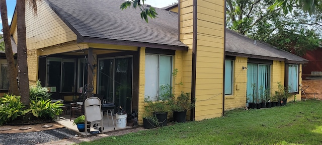 view of side of property with a lawn