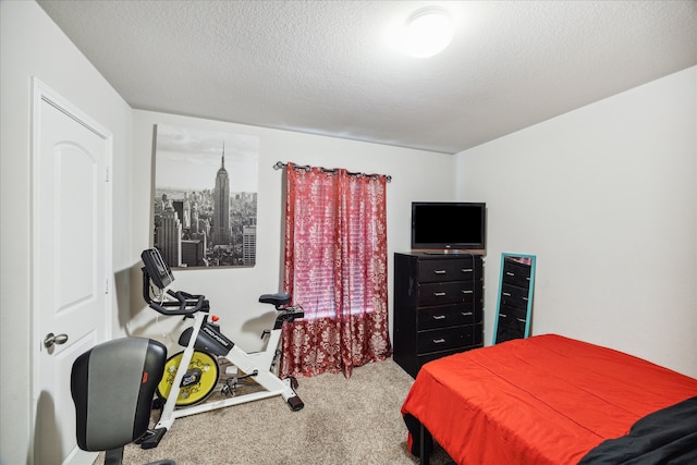 carpeted bedroom featuring a textured ceiling