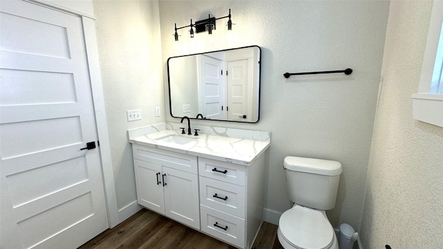 bathroom featuring vanity, toilet, and wood-type flooring