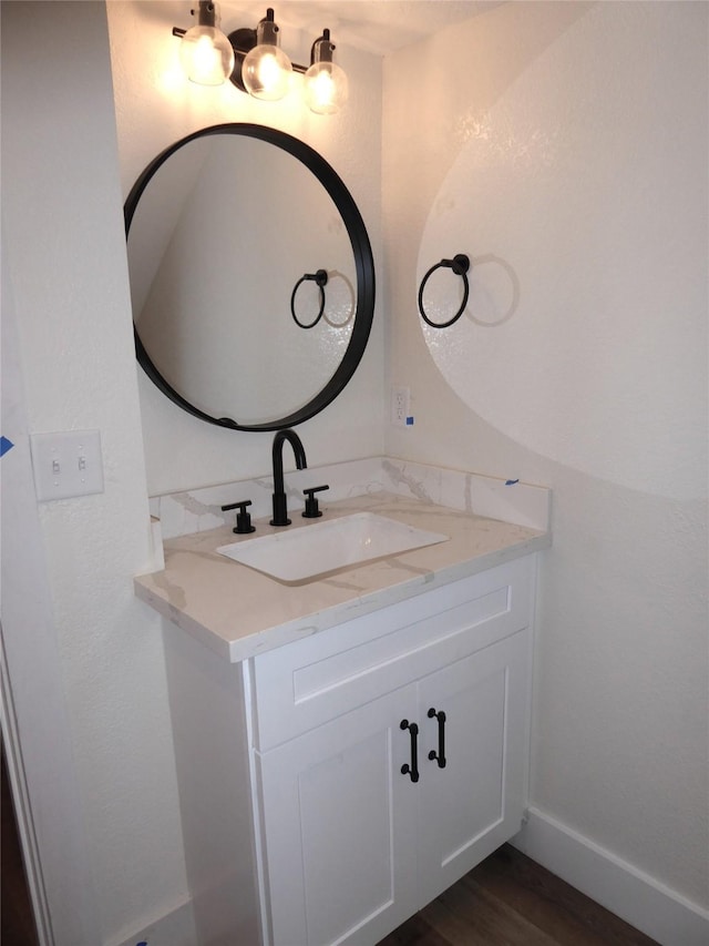 bathroom with hardwood / wood-style floors and vanity