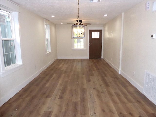 foyer entrance featuring dark hardwood / wood-style floors, ceiling fan, and a textured ceiling