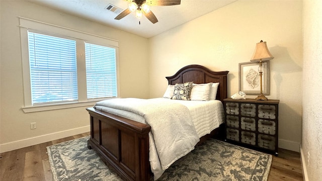 bedroom featuring dark hardwood / wood-style flooring and ceiling fan