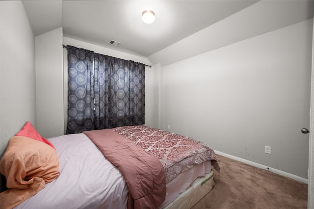 bedroom with vaulted ceiling and carpet floors