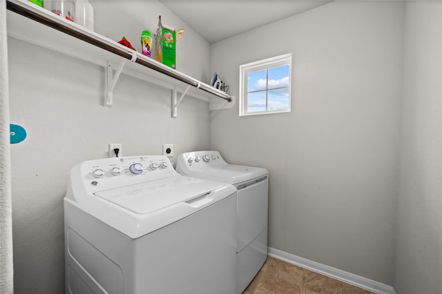 laundry room with washing machine and dryer and tile patterned floors