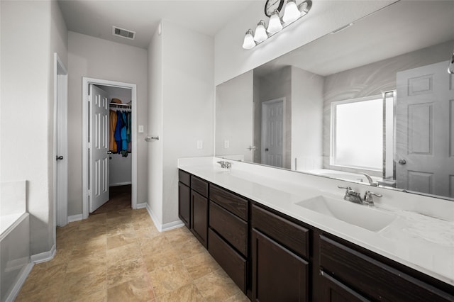 bathroom with a tub to relax in and vanity