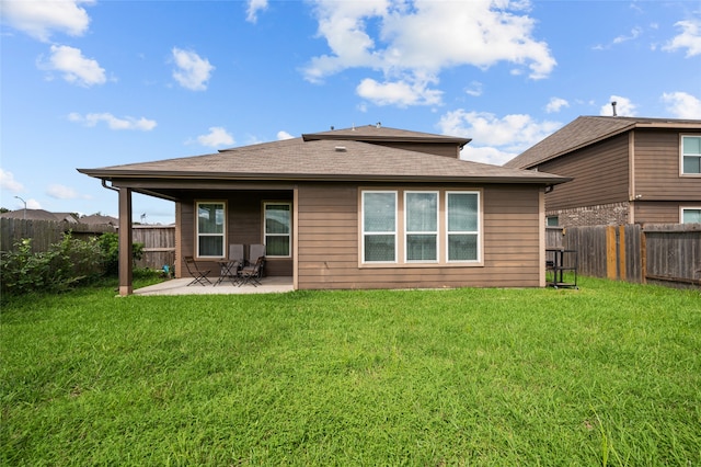 rear view of house with a patio area and a yard