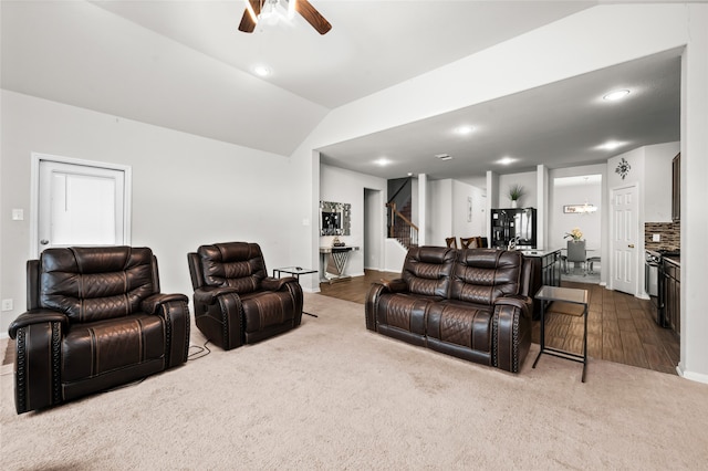 living room with lofted ceiling, ceiling fan, and hardwood / wood-style flooring