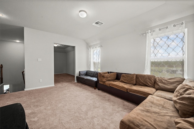 carpeted living room featuring vaulted ceiling