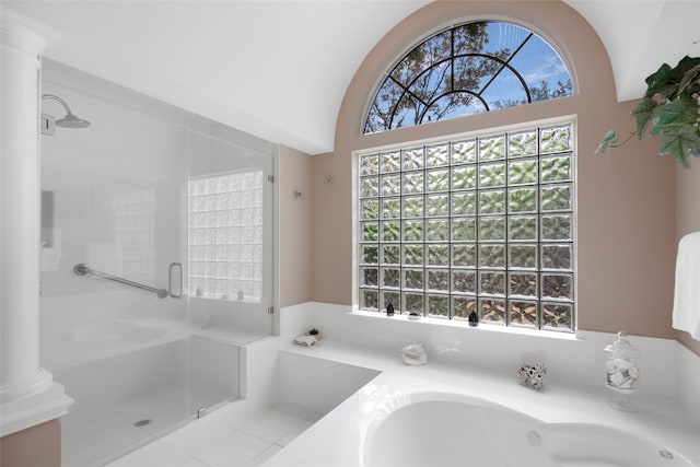 bathroom featuring vaulted ceiling, shower with separate bathtub, and ornate columns