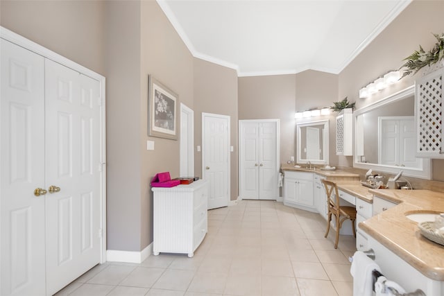 bathroom with tile patterned floors, crown molding, and vanity