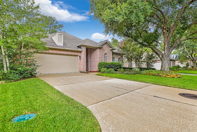 view of front of property with a front lawn and a garage