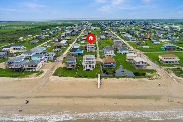 drone / aerial view featuring a water view and a beach view