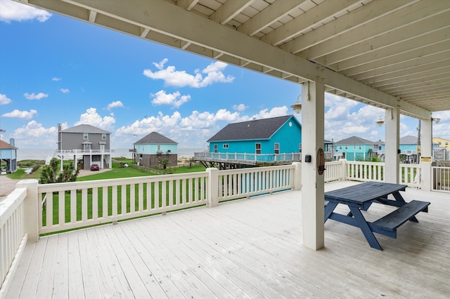 wooden terrace featuring a lawn