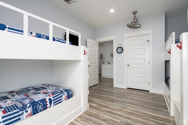 bedroom with hardwood / wood-style floors