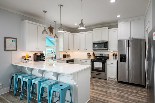 kitchen with appliances with stainless steel finishes, sink, and white cabinets