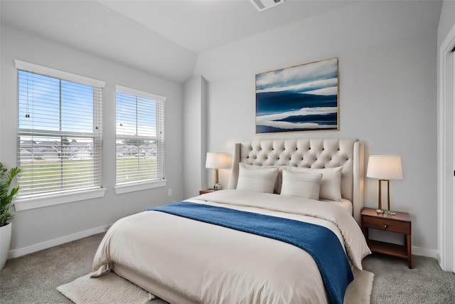 bedroom featuring lofted ceiling, baseboards, and carpet floors