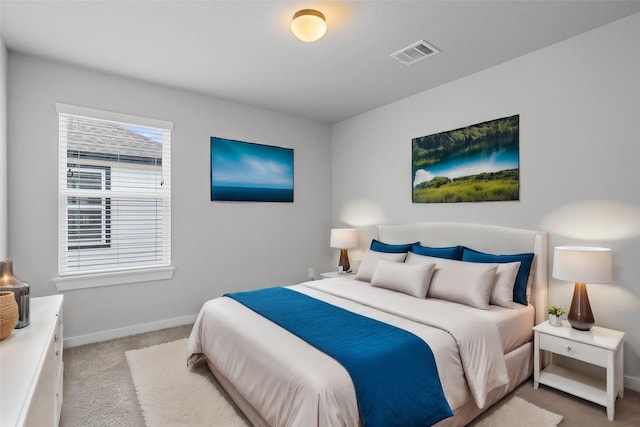 bedroom featuring baseboards, visible vents, and carpet floors