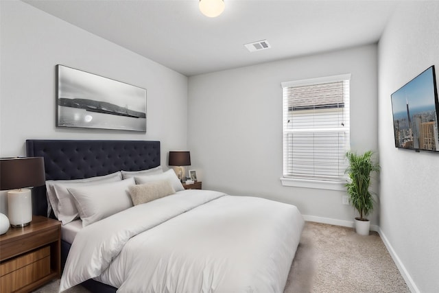 carpeted bedroom with baseboards and visible vents